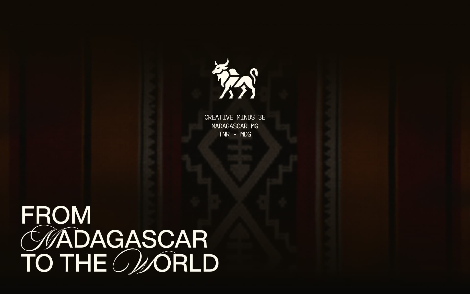 Hero of the 2026 home page: the zebu emblem above three lines of monospaced text, “Creative Minds 3E, Madagascar MG, TNR - MDG”, over a dark woven textile, with the title “From Madagascar to the World” in the lower left.